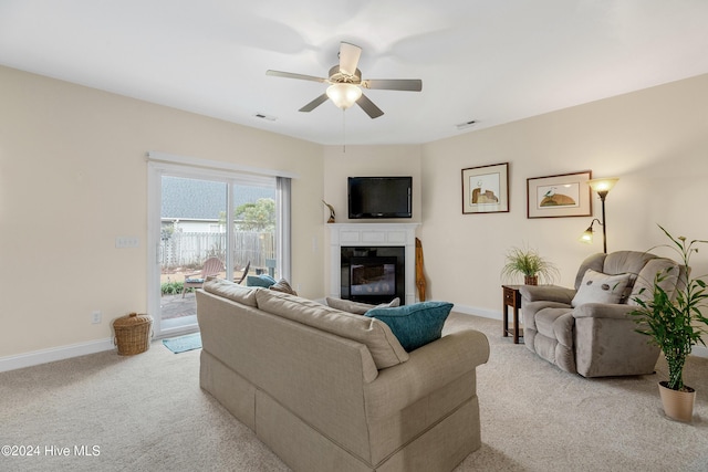 carpeted living room featuring ceiling fan