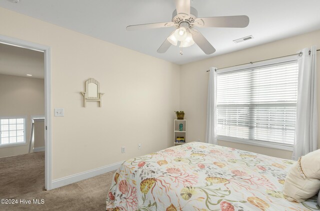 bathroom with toilet, vanity, tile patterned flooring, and walk in shower