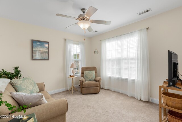 bedroom with ceiling fan and light carpet