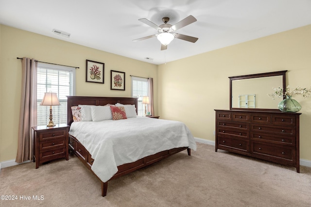 bedroom with ceiling fan and light carpet