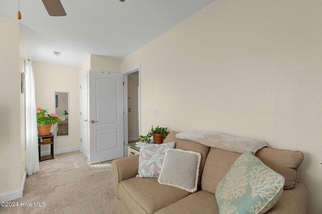 sitting room featuring ceiling fan and light carpet