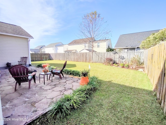 view of yard with an outdoor fire pit and a patio