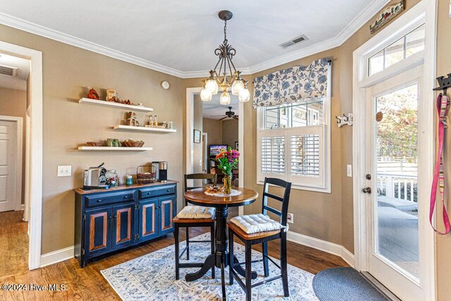 154 Horizon Trl, Aberdeen, NC 28315 - dining room featuring dark wood-style flooring, baseboards, ornamental molding, a chandelier, and a ceiling fan