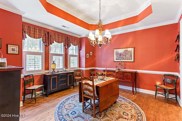154 Horizon Trl, Aberdeen, NC 28315 - dining area featuring a chandelier, light wood-style floors, a raised ceiling, and ornamental molding