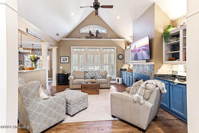 154 Horizon Trl, Aberdeen, NC 28315 - living room with high vaulted ceiling, ceiling fan, ornate columns, dark wood-type flooring, and baseboards