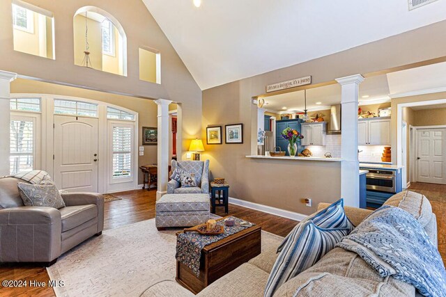 154 Horizon Trl, Aberdeen, NC 28315 - living area featuring decorative columns, wood finished floors, high vaulted ceiling, baseboards, and recessed lighting
