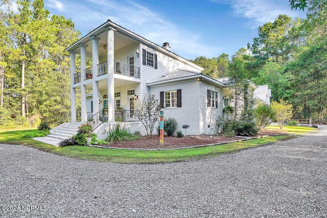 view of front of property with a porch and a balcony