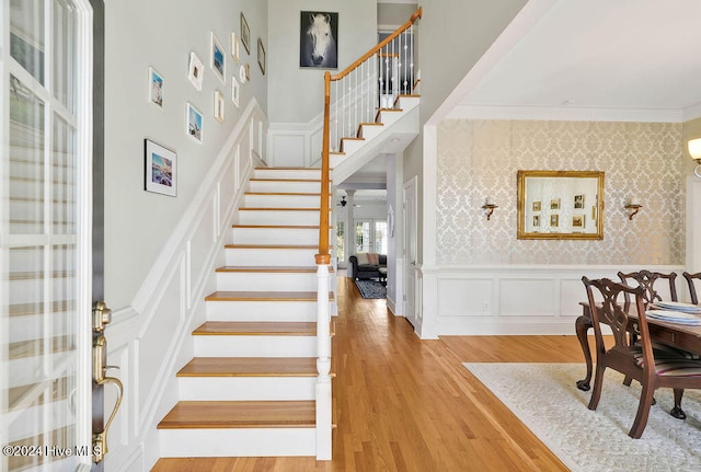 interior space featuring hardwood / wood-style floors and crown molding