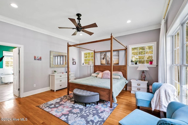 bedroom with light hardwood / wood-style floors, ceiling fan, and crown molding