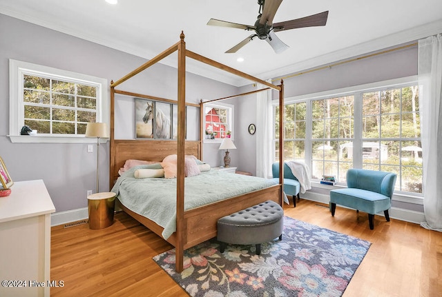 bedroom with ornamental molding, light hardwood / wood-style floors, and ceiling fan