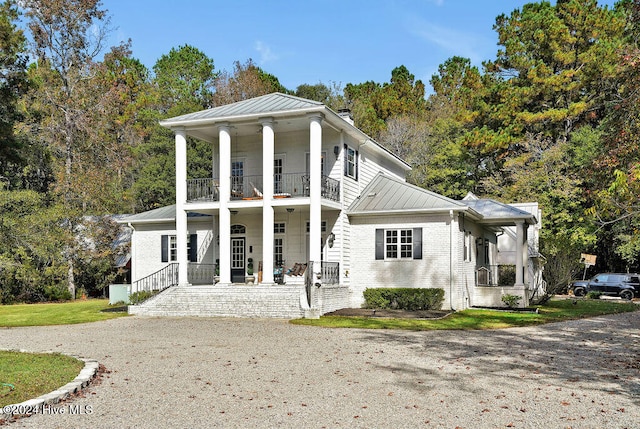 view of front of home featuring a balcony and covered porch