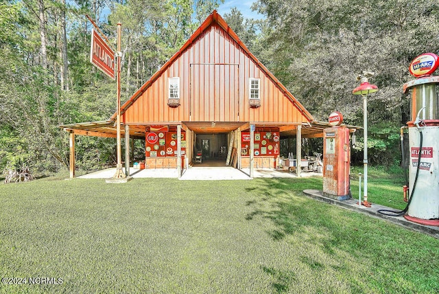 rear view of property featuring water heater and a lawn