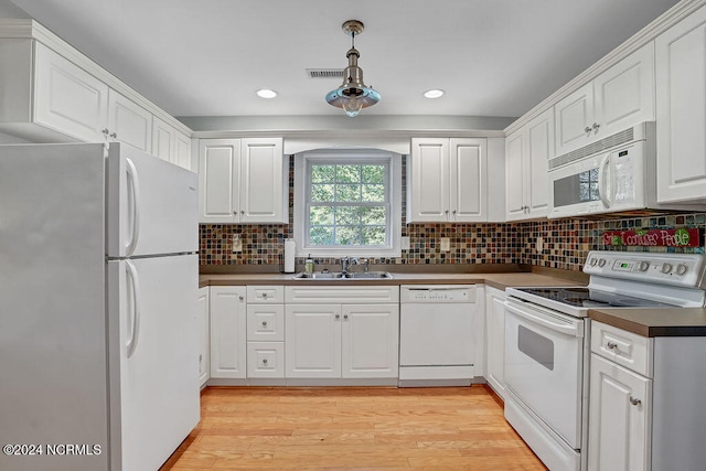 kitchen with white appliances, white cabinetry, sink, and light wood-type flooring