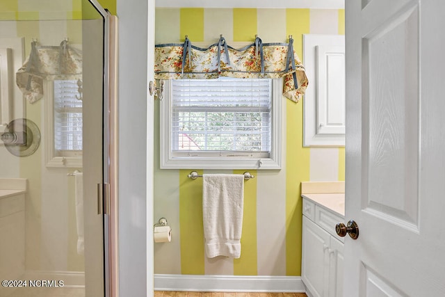 bathroom with vanity and a shower with shower door