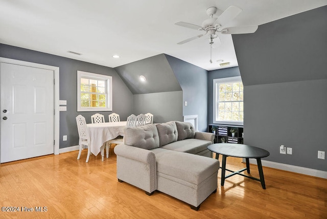 bedroom with ceiling fan, multiple windows, lofted ceiling, and light hardwood / wood-style floors