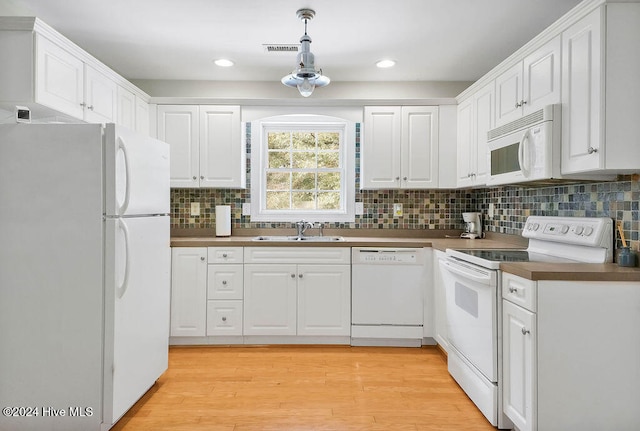 kitchen featuring white cabinets, light hardwood / wood-style flooring, sink, and white appliances