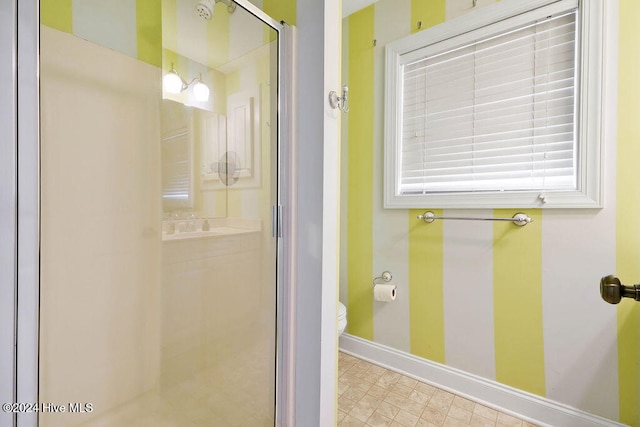 bathroom with toilet and an enclosed shower