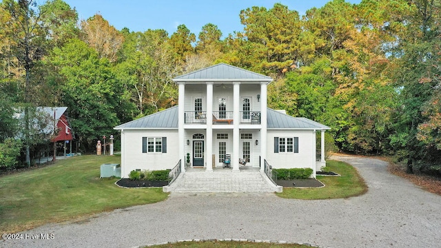 neoclassical / greek revival house with a balcony, a front yard, french doors, and a porch