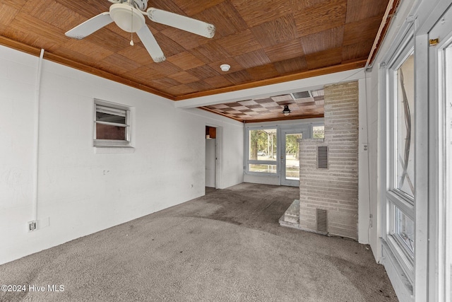 spare room featuring ceiling fan, wood ceiling, and carpet flooring