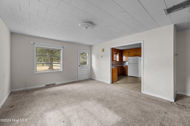 unfurnished living room featuring light colored carpet