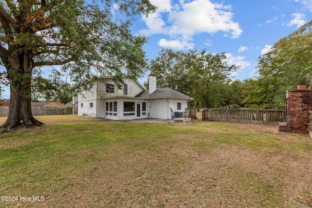 back of property with a lawn and a patio area