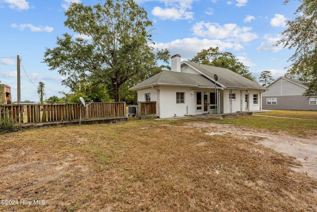 back of house with a yard