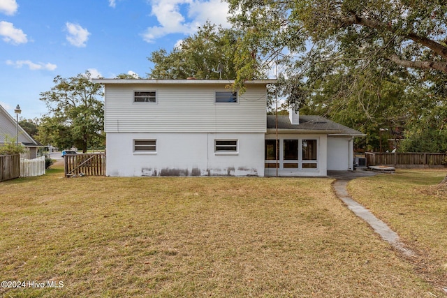 rear view of house with a lawn and a patio area