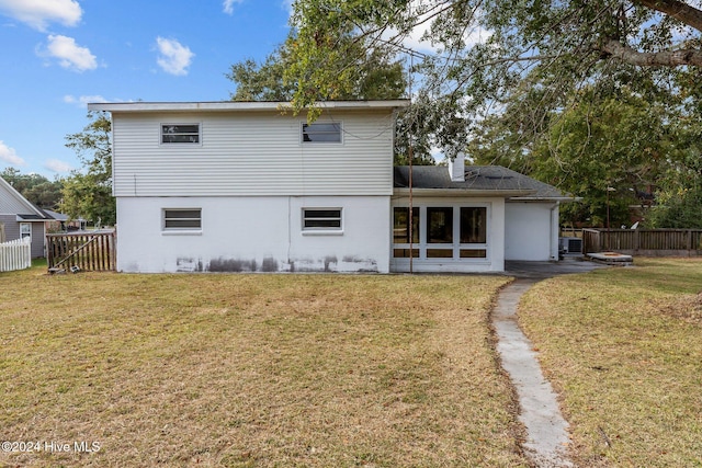 back of property featuring a patio and a yard