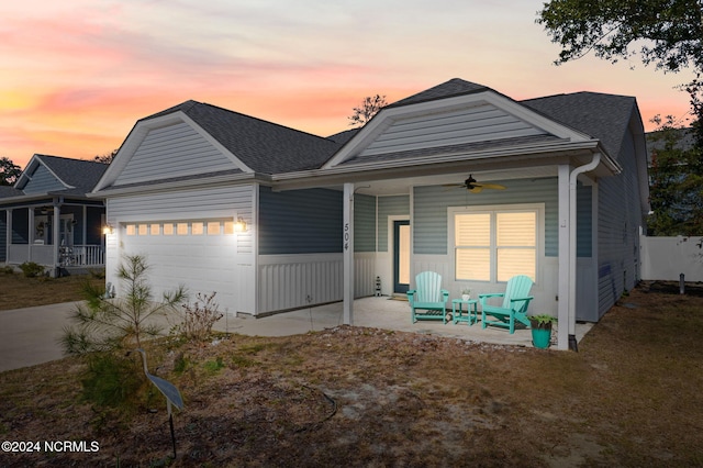 view of front of house featuring a garage and ceiling fan