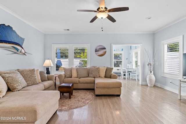 living room featuring light hardwood / wood-style floors, a healthy amount of sunlight, and ceiling fan