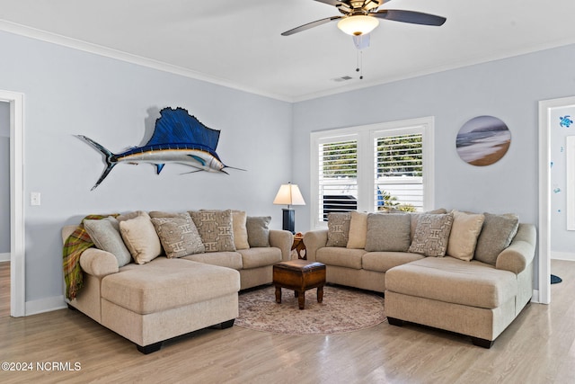 living room featuring light hardwood / wood-style flooring, ceiling fan, and crown molding