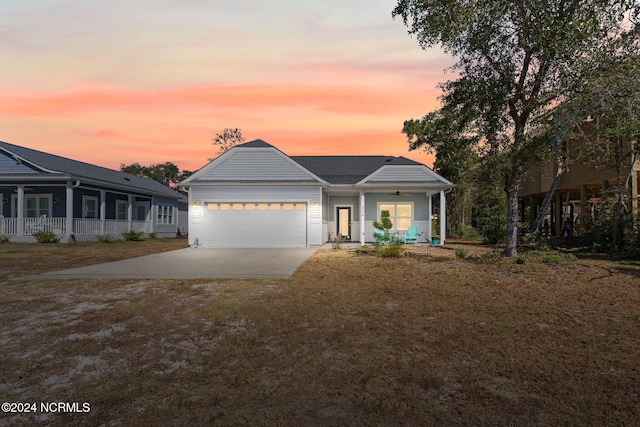 view of front of property featuring covered porch and a garage