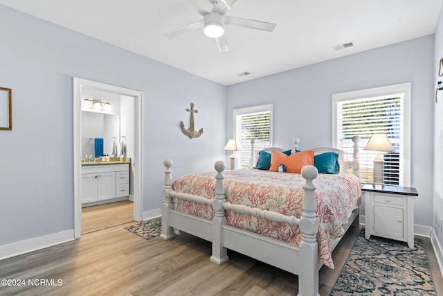 bedroom with ceiling fan, light hardwood / wood-style floors, and ensuite bath