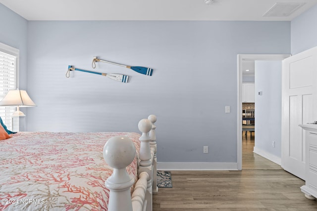 bedroom with wood-type flooring