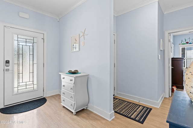 entrance foyer featuring crown molding and light hardwood / wood-style flooring