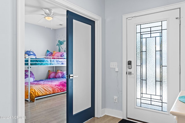 entryway with light hardwood / wood-style floors and ceiling fan