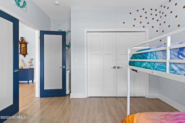 bedroom featuring light wood-type flooring and a closet