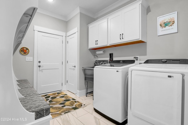 washroom with cabinets, washer and clothes dryer, crown molding, and light tile patterned flooring