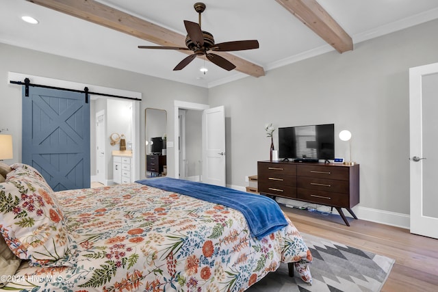 bedroom featuring ceiling fan, a barn door, ensuite bathroom, beam ceiling, and light wood-type flooring