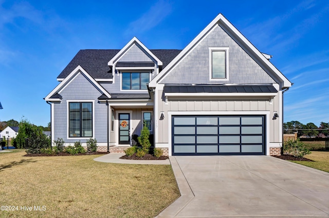 craftsman inspired home with a garage and a front yard