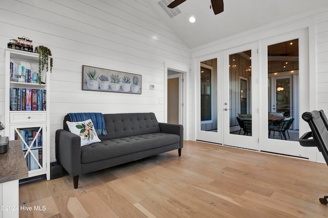 living room featuring high vaulted ceiling, ceiling fan, light hardwood / wood-style flooring, and french doors