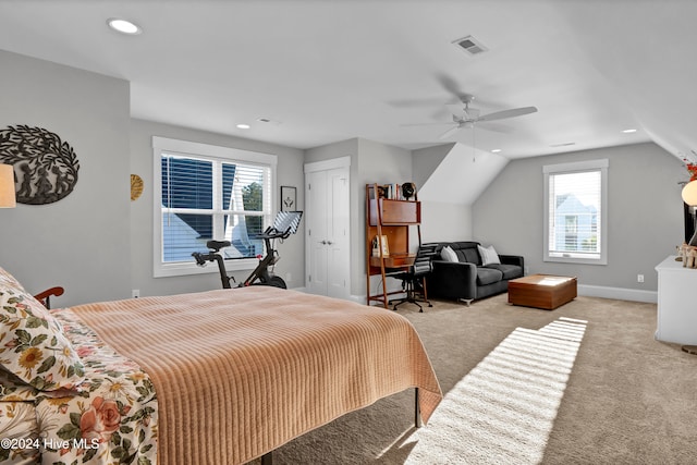 bedroom featuring ceiling fan, light colored carpet, and vaulted ceiling