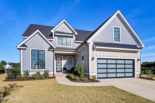 view of front of house with a garage and a front lawn