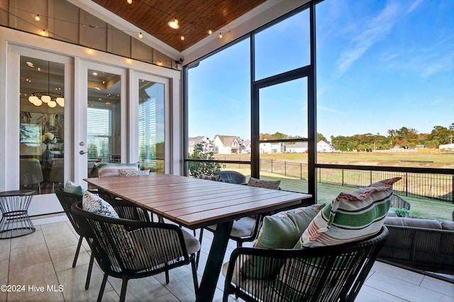 sunroom / solarium featuring lofted ceiling and wooden ceiling