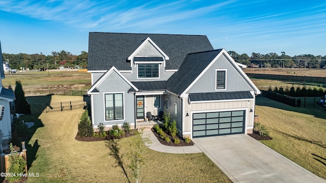 modern farmhouse featuring a front lawn and a garage