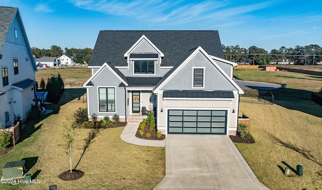 view of front of house featuring a front yard and a garage