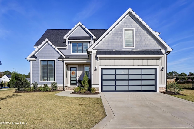 view of front of house featuring a front lawn, concrete driveway, board and batten siding, a standing seam roof, and metal roof
