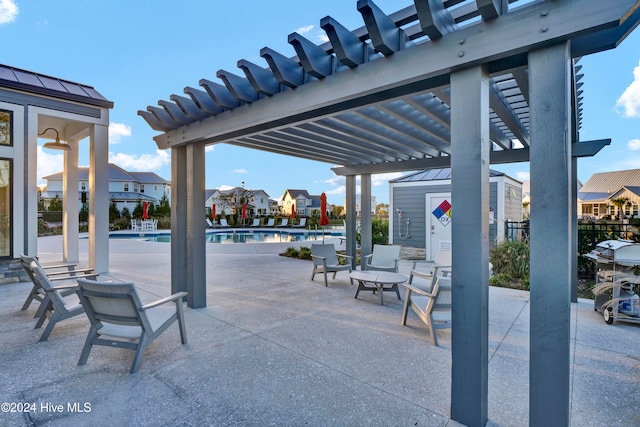 view of patio / terrace featuring a community pool and a pergola