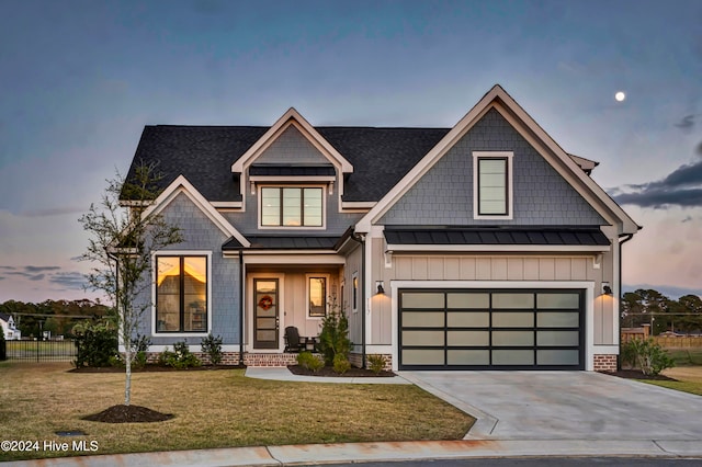 view of front of house featuring a garage and a yard