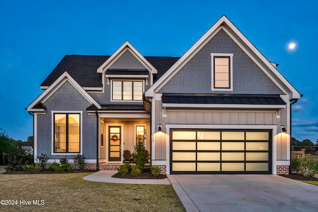 view of front of home with a front yard and a garage